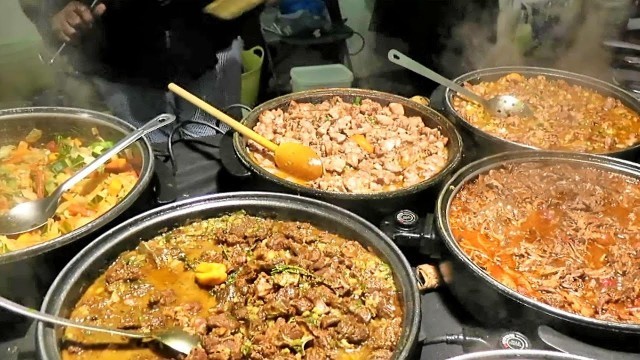 'London Street Food. Preparing Caribbean Food from Jamaica. Seen in Brick Lane'