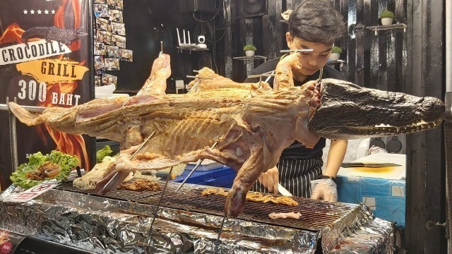 'Whole Crocodile Cut and Grilled. Thai Exotic BBQ. Street Food in Phuket, Thailand'