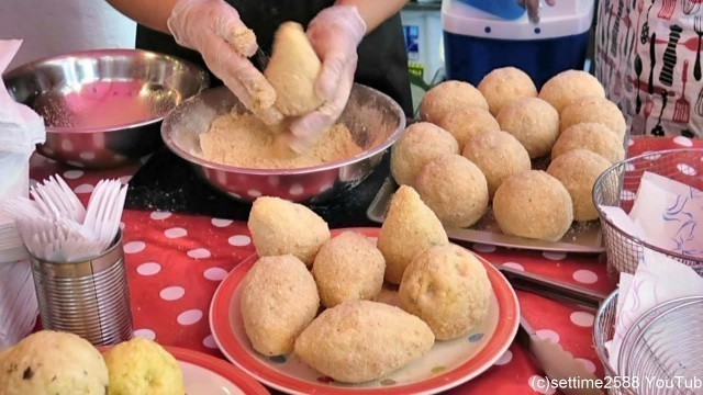 'London Street Food from Sicily, Italy. Preparing Rice Arancini and Cannoli. Brick Lane'