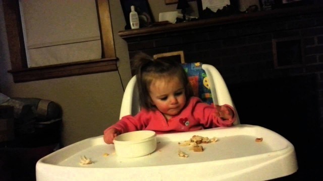 '13 month old puts food in and out of bowl'